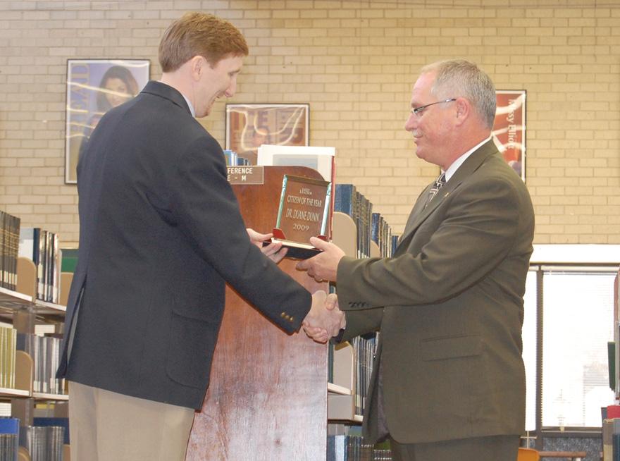 Crusader photo/ Rustin Watt 

Dr. Dunn shakes hands with Earl Watt as Dunn receives the High Plains Daily Leader “Citizen of the Year” award. Dunn won the award because of his work with the merger and many other community activities.