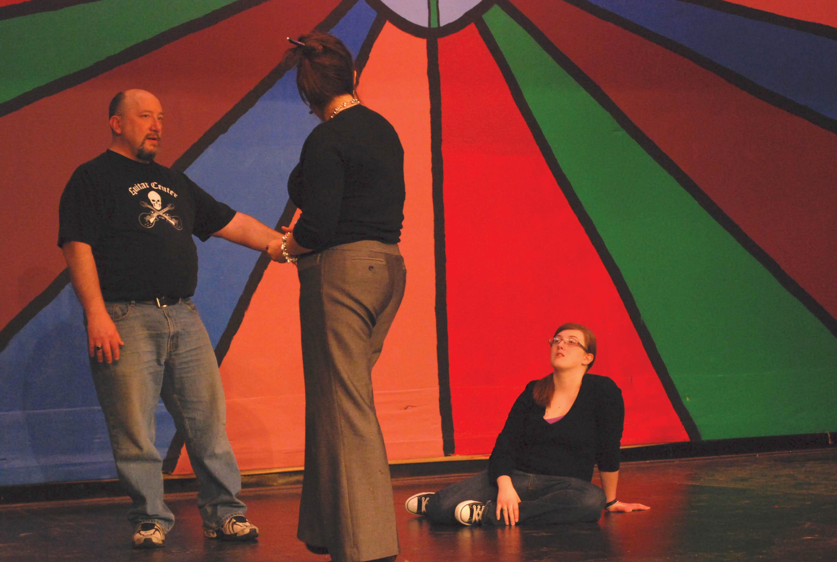 Crusader photo/ Jose Rodriguez
Alison Chambers directs Tony Claus and Lauren Peck in a scene. The musical “Beauty and the Beast” will be at 7:30 p.m. April 22-24. Tickets are $6 for a seat on the side and $8 for center seats. They will be $10 at the door. Tickets are available in the humanities office H116 or by calling 620-417-1451.  Students are admitted free of charge with a current SCCC/ ATS ID. For more backstage photographs see the multimedia section of CrusaderNews.com. 