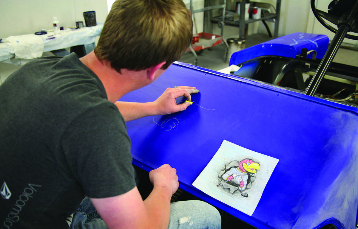 A member of the auto body department, of the technical school, above, decorates a vehicle during the open house at the technical school during the Spring Fiesta. Rows of cars, right, were lined up for the car show. Sixty vehicles were entered in the car show and many local citizens took the time to visit and tour the college and technical school.