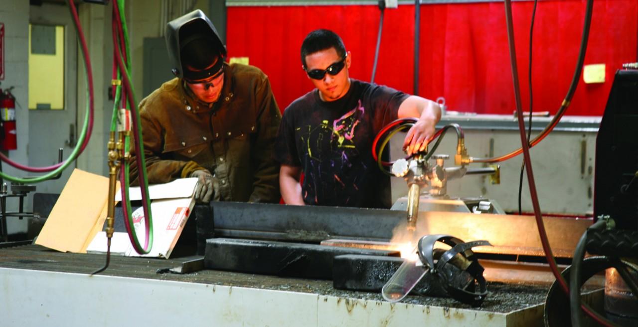 Courtesy photo/ Pam Freeman
Rey Lujan and Juan Cerda demonstrate their work in the welding department during the Spring Fiesta and Car Show. The technical school had an open house during the fiesta. More photos on page 6.