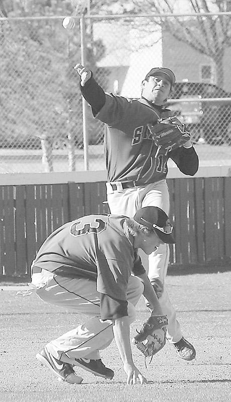 Crusader photo/Rustin Watt
David Cruz makes a throw while third baseman Quay Grant ducks  to avoid Cruz’s throw. The play registered an out  against the Dodge City Community College Conquistadors. Seward swept Dodge in the series. 
