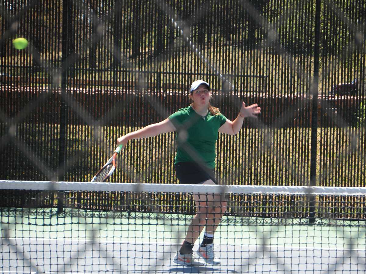 Courtesy photo/ Jackie Arnold Kathryn Roohan, sophomore and captain for the Lady Saints women’s tennis team serves at a match on Saturday, April 27 in Wichita.