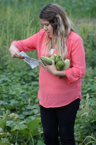 Liberal resident Lorena looks at a sheet to see what can be picked at Tuesday pickings. Lorena is a mother who comes each Tuesday because she likes fresh vegetables.