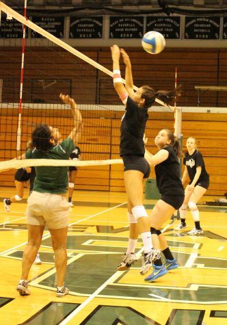 Saints volleyball practices their net game.