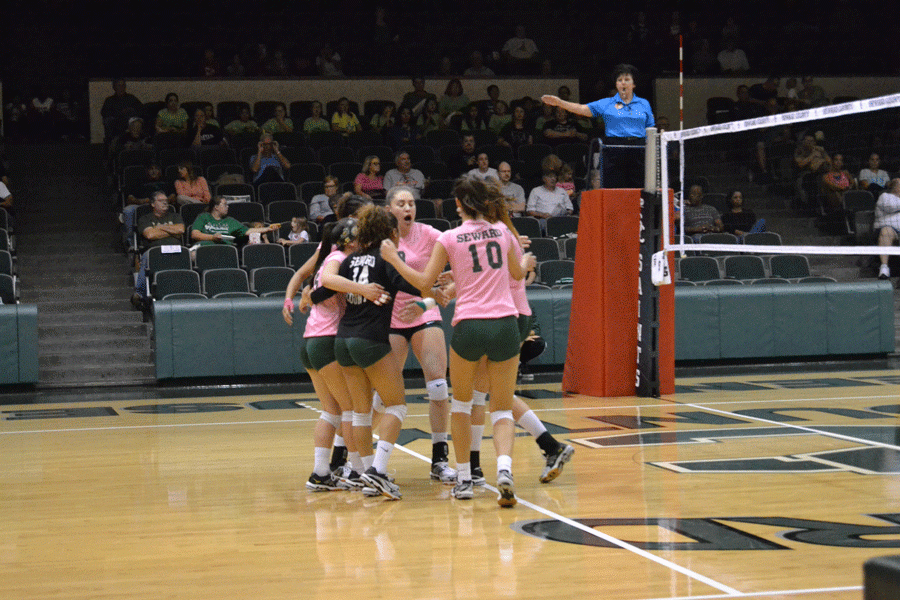 Lady saints celebrating after an exciting point against Cloud County.