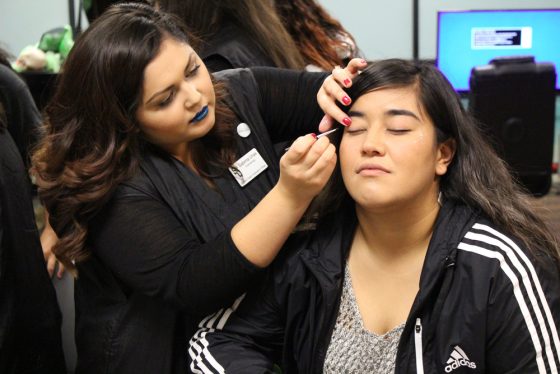 To help brighten up her face for National Student Day, Sabrina Urias gives Judith Perez a glitter star on her cheek.