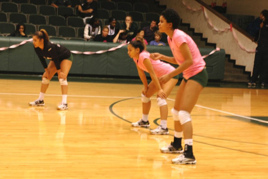 Crouching into position, Jazlyn Smith, Diamond Aguinaldo and Maritza Mesa are waiting for a serve to come their way. Mesa scored 13 kills on Barton over the course of four games.
