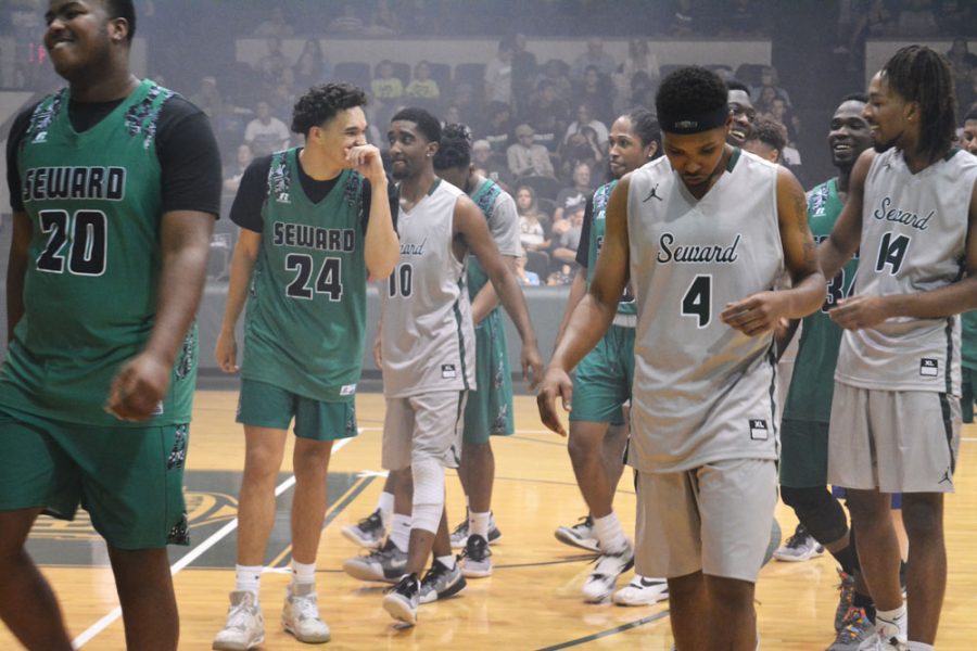 The Saints Basketball team saunter about the court in a show of fun and good spirit. The team is ranked third for the Jayhawk West Conference season.