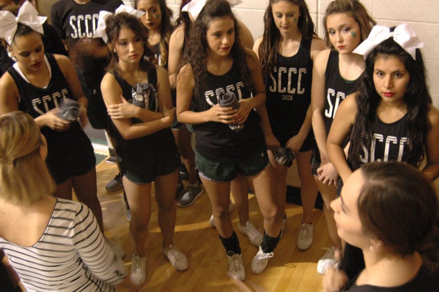 Cheer and dance coaches Brianna Ruiz and Stefani Croy give one final pep-talk before the team takes the Greenhouse floor.