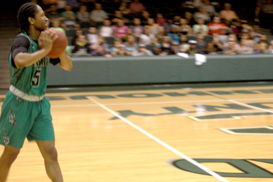 Preparing to style a dunk, sophomore Jeromie Simmons takes the ball down the court. Simmons executed an incredible dunk that earned him a full score to win him the annual Saints Bookstore dunking competition.