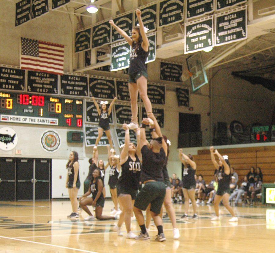 In a stunning display of skill, the Saintsations cheer and dance team hit their stunts as the crowd cheers.