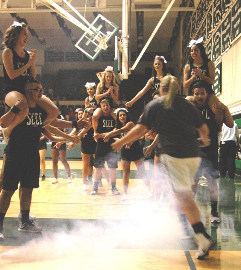 The Saintsations gather around to welcome Mollie Mounsey, freshman guard from Follett, Texas, to the court. 