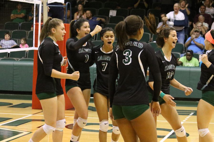 After taking an important point lead, the Lady Saints celebrate their well executed play.