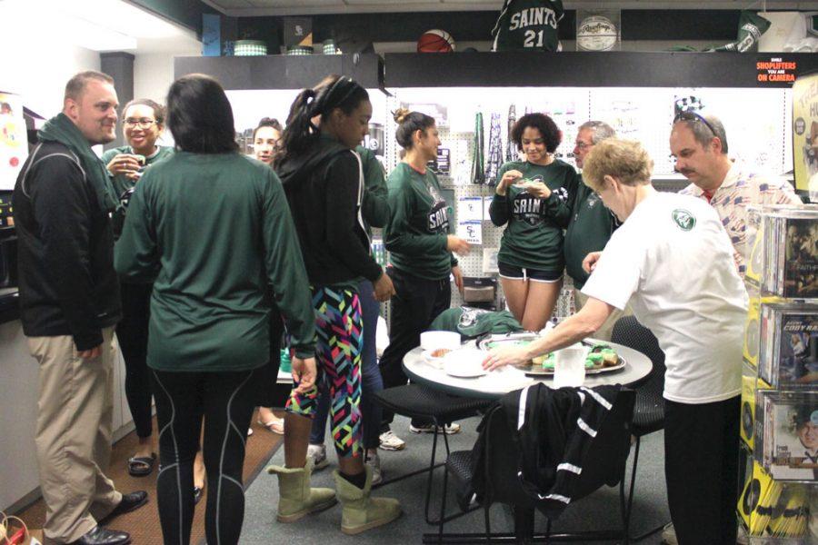 Faculty and staff meet in the Saints Bookstore to congratulate the Lady Saints volleyball players. Celebrating with cupcakes, Saints talk about their excitement going into the tournament.