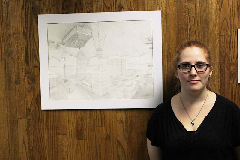 Visual arts major Rosa Strydom shows off one of her art pieces that was entered into the art exhibit. 