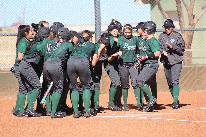 The lady saints celebrate a home run by using a cooking motion as a sign of scoring.