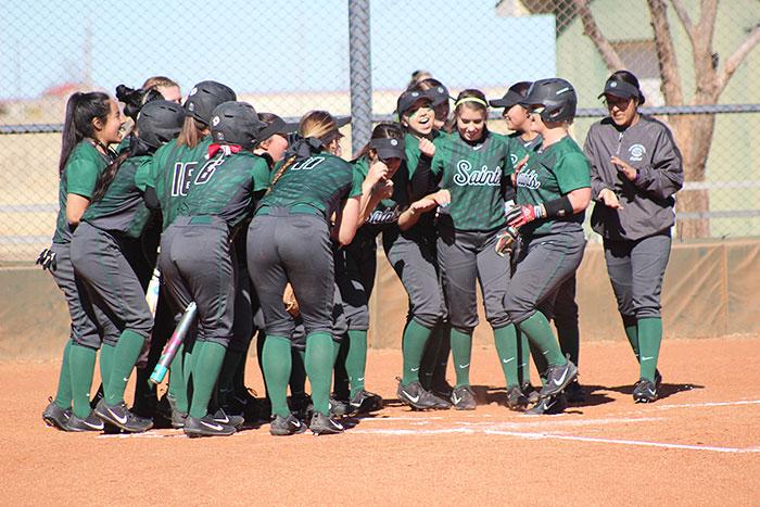 The+lady+saints+celebrate+a+home+run+by+using+a+cooking+motion+as+a+sign+of+scoring.