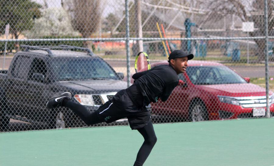 Sophomore Carlos Anez returns the ball to his opponent. Anez started the Saints off with a win in singles downing James Ryan 6-3, 6-4 to put Seward up 3-1.