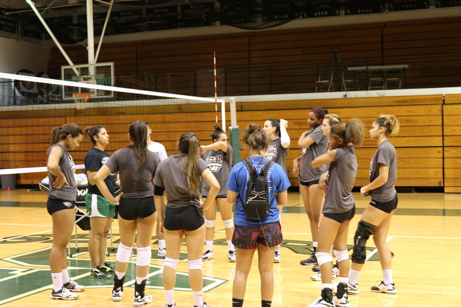 The Lady Saints gather around Coach Thais Allen  to discuss about what they are going over during practice. 
