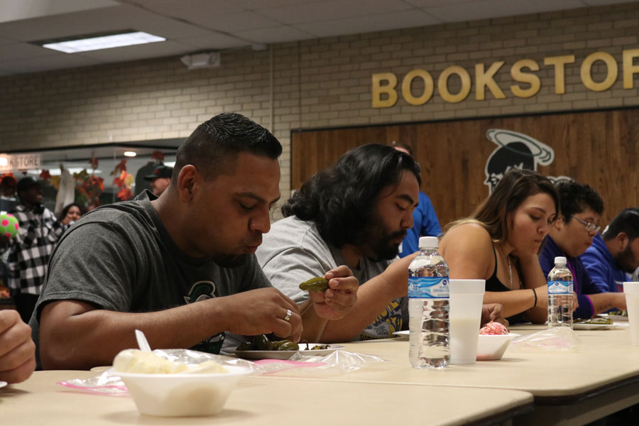 SCCC students rush to eat the pickle jalapenos in the contest. The contestants were able to remove the stems before the contest started to make the jalapenos easier to eat.  
