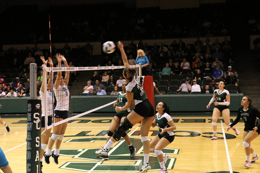 Sophomore Viviane Viana soars in the air to earn a kill against the Colby Trojans. 