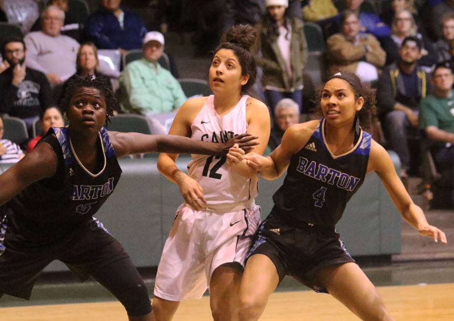 Sophomore Valerie Caro tries to break free during a free-throw box out. Valerie Caro finished with three rebounds against Barton Community College.
