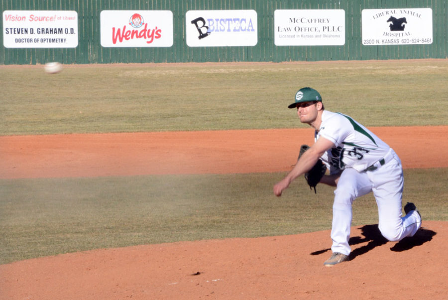 Ethan Earhart pitches a few practice throws before the game starts. Earhart pitched three of the nine innings.