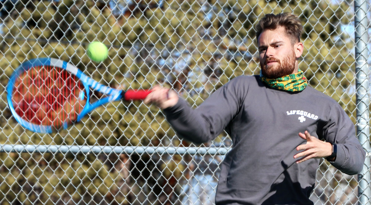 Sophomore, Borja Font, soars in the air to whip the tennis ball across the court. The tennis team spends hours practicing their forehand and backhand from the baseline. The men's and women's teams start their season this weekend with a tournament in Tyler, Texas.