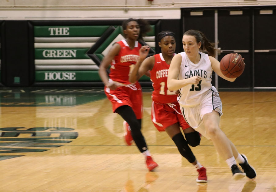 Freshman, Chelsea Lazenby dribbles past her opponents after getting a steal during the second half. Lazenby had seven points, three assists and a steal.