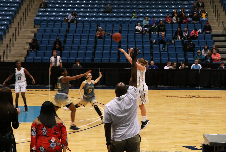 SCCC Women's Basketball Assistant Coach Carlo Walton cheers the Region VI Tournament MVP Mollie Mounsey as she swishes a three pointer.