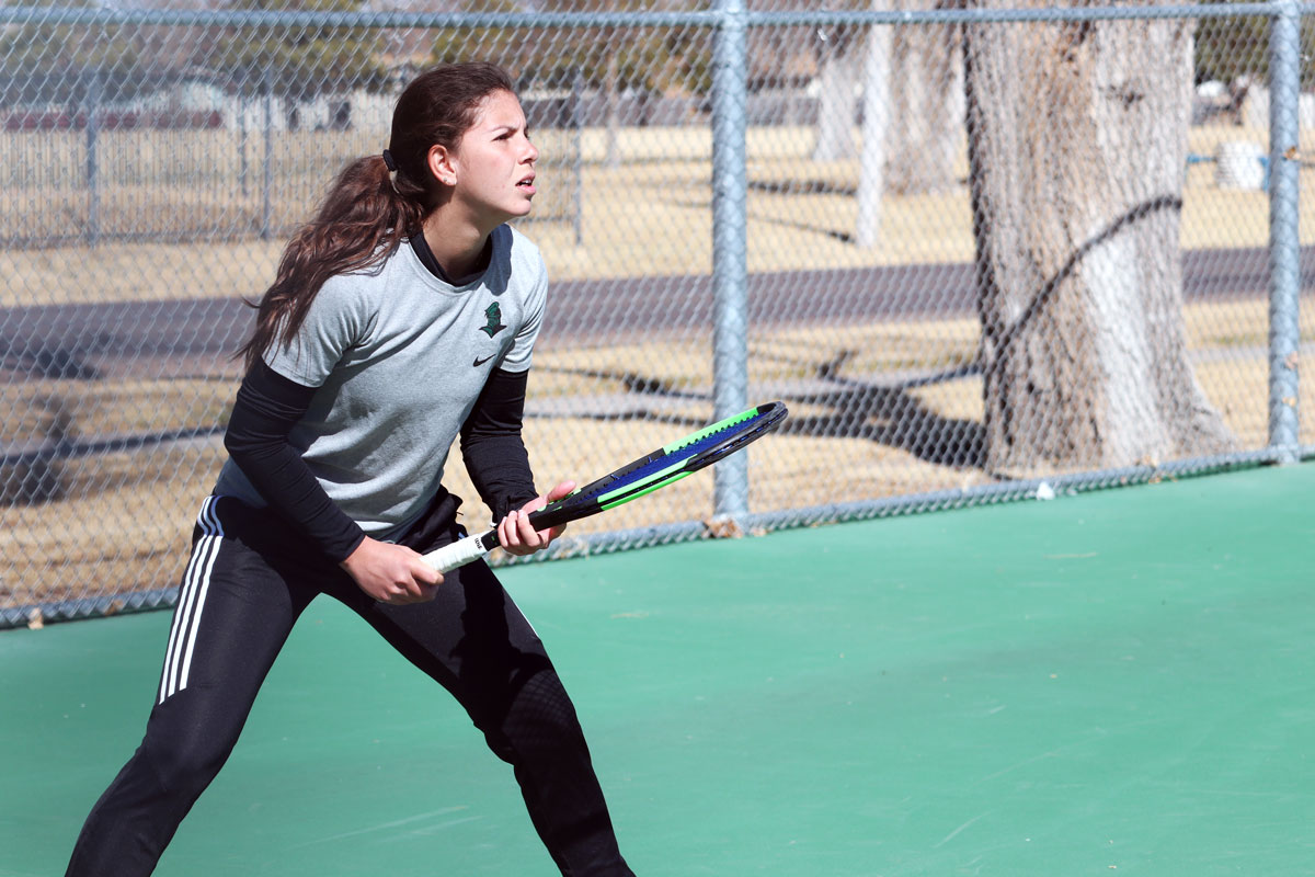 Freshman, Maria Aveiga prepares to receive a serve from her opponent. Aveiga dominated the number two spot, 6-4 and 6-3.
