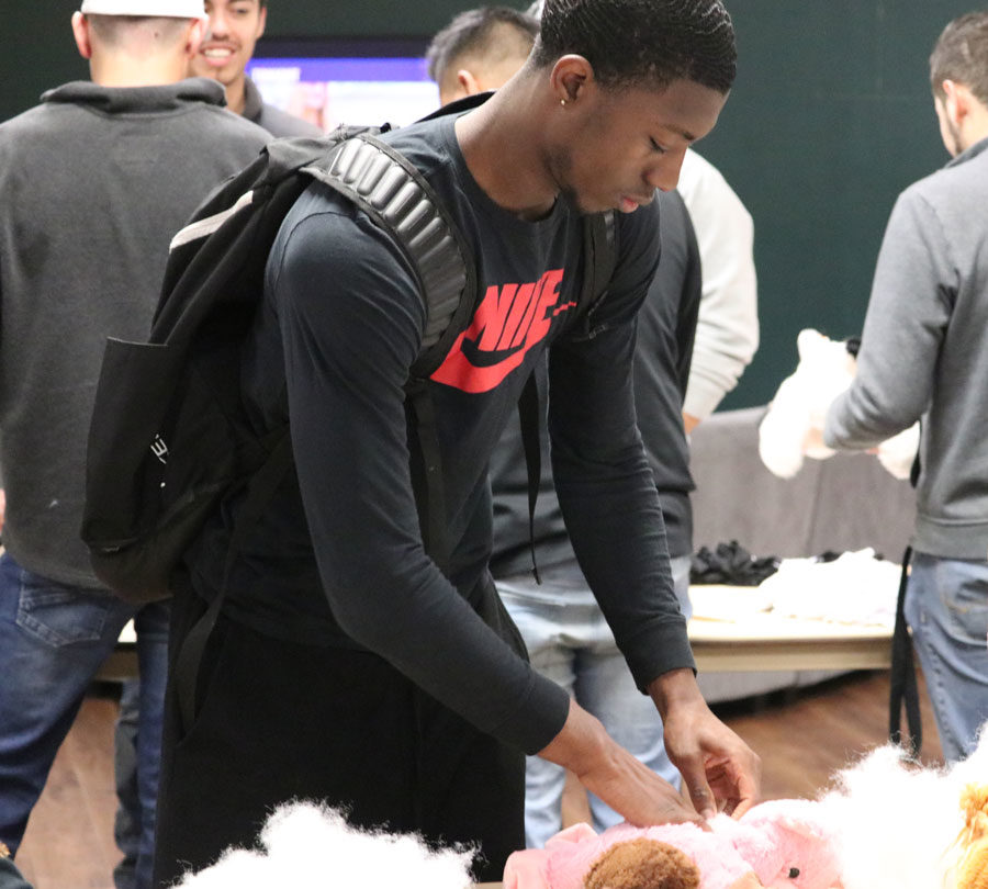 Jamel Horton, freshman, attends the de-stress week event in the Student Union. Horton chose a pig to be his stuffed animal. “I named him Loso Mel Jr., after me, and I chose the pig because I thought he looked cooler than the other choices. Also, my stuffed animal is from Queens, NY, just like me,” Horton, said. 
