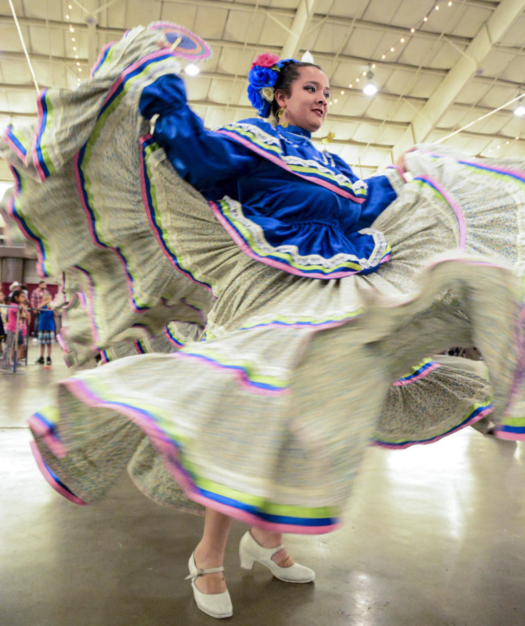 A member of El Grupo de Danza Ballet Folklórico Omawari  de Delicias Chihuahua twirls in circles while balancing an object on her head. The weekend-long Cinco de Mayo celebration, May 3-5, included a queen and princess competition, Seward County Community Colleges graduation, a Cinco de Mayo parade, food, eating contests and traditional dancing.