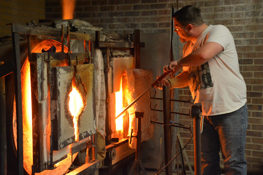 SCCC glassblowing instructor Matthew Williams works with molten glass to create a new piece of art during his class Feb. 4 at Liberal High School. Williams got his own start in this class years ago and now teaches SCCC students and community members to shape their own glass art.