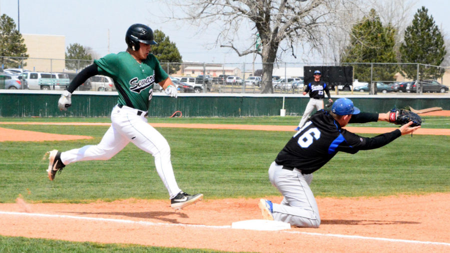 Jose Caraballo, sophomore shortstop from Puerto Rico, stretches out his stride to beat the throw to first base. He was called out by half a step. The Saints swept the doubleheader against Barton Community College on March 28.