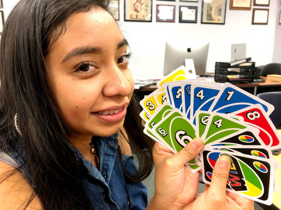 Rubi Gallegos, photo editor, got stuck with a lot of cards in a game of UNO. The staff Christmas party included a VERY heated card game.