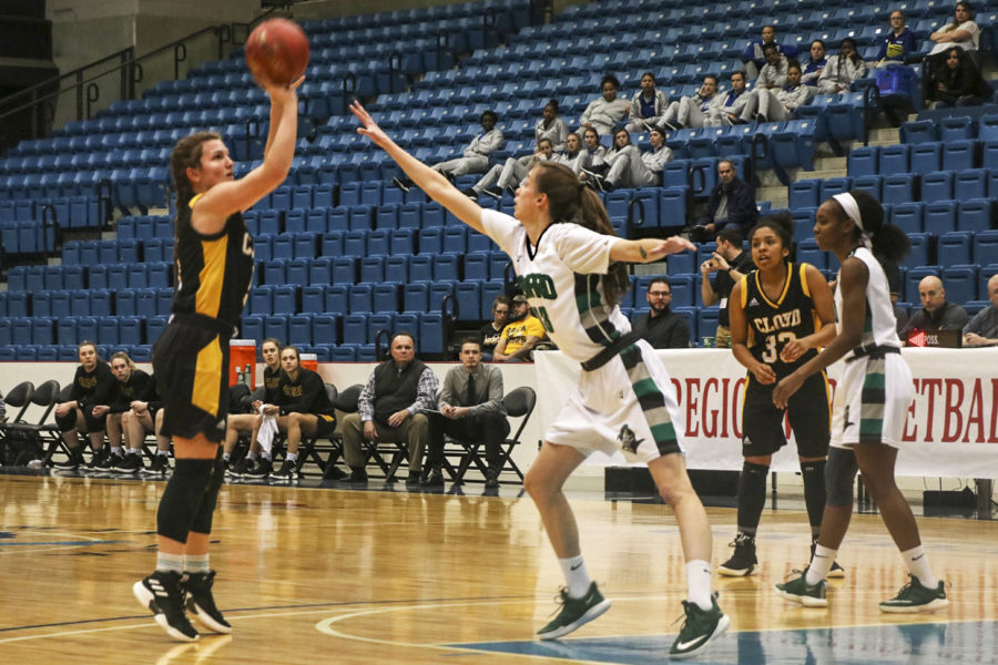 Karolina Szydlowska, forward from Wroclaw, Poland, attempts to block a shot ,trying to keep the Lady Saints ahead. Seward won the game easily 74-59 over Cloud County and advanced to the quarterfinal game at 3 p.m. Monday.