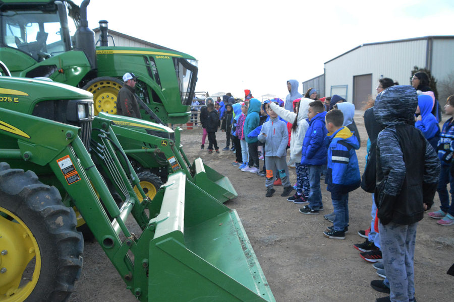 Students+gather+around+tractors+and+discuss+their+roles+in+agriculture.+This+was+part+of+farm+day+on+Mar.+19.