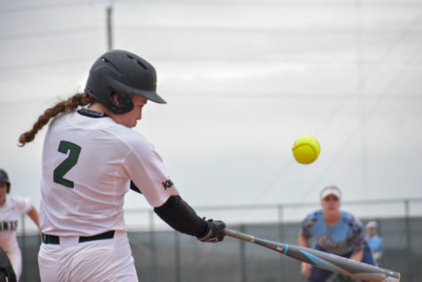 Jaci Oakley, freshman infielder, pops a shallow fly ball between third and left field for her first hit of the game April 3, against Otero Junior College. The Lady Saints split the doubleheader losing the first game, 3-7, but won the second, 10-5.