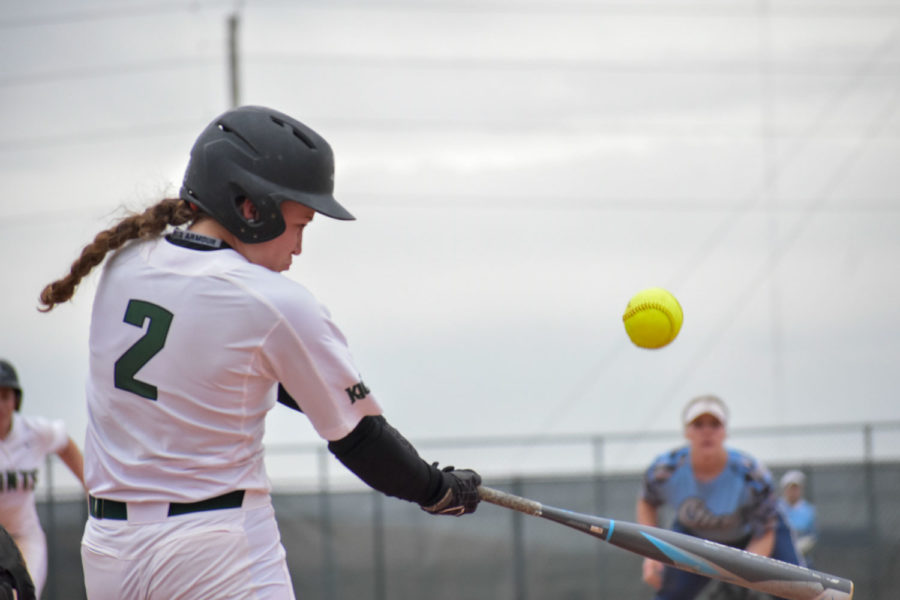 Jaci Oakley, freshman infielder, pops a shallow fly ball between third and left field for her first hit of the game April 3, against Otero Junior College. The Lady Saints split the doubleheader losing the first game, 3-7, but won the second, 10-5. 
