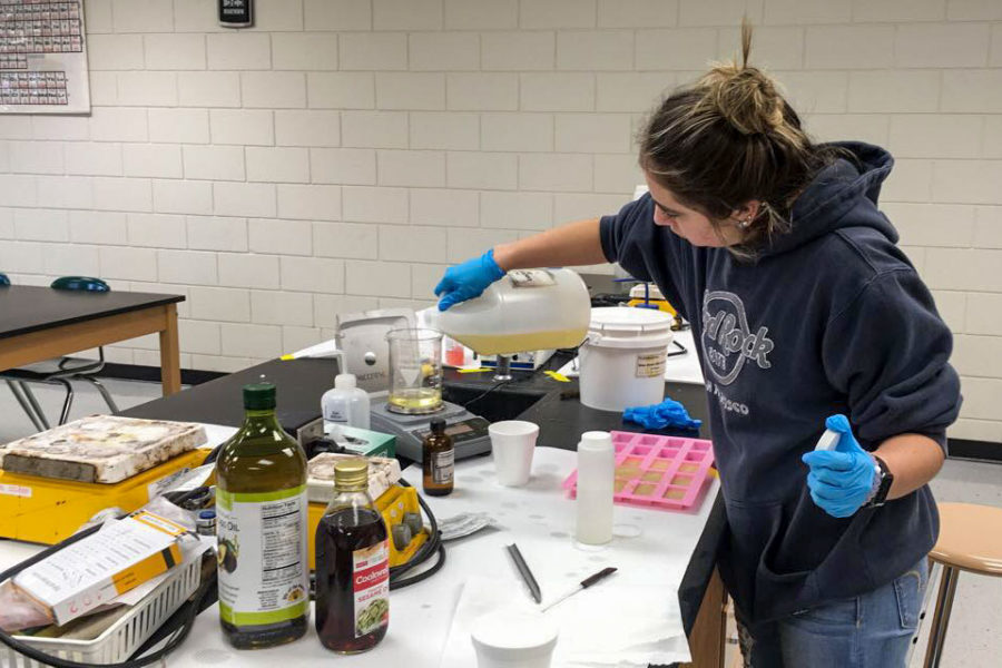 Hayden Marties measures ingredients for a lab project making soap. For many chemistry II students, it was trial and error. Calculations had to be made to make sure the right combination of oil and lye was mixed. Too much lye is could cause burning to skin.