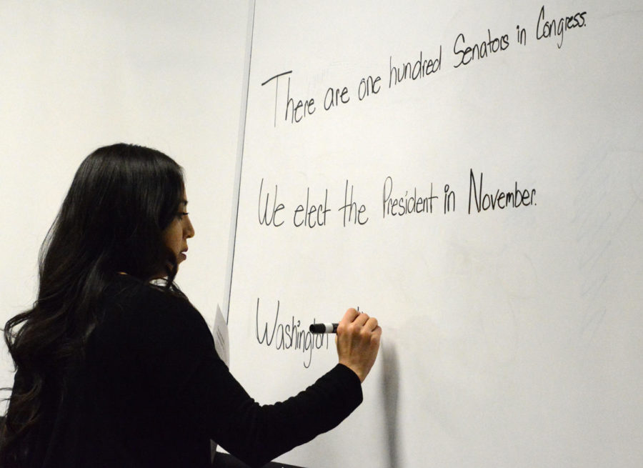 Janeth Vasquez writes study helps on the board. She encourages her students to rewrite these to help them memorize key points that might be on the citizenship test. Vazquez not only teaches the citizenship class but she is also the SCCC transfer coordinator.
