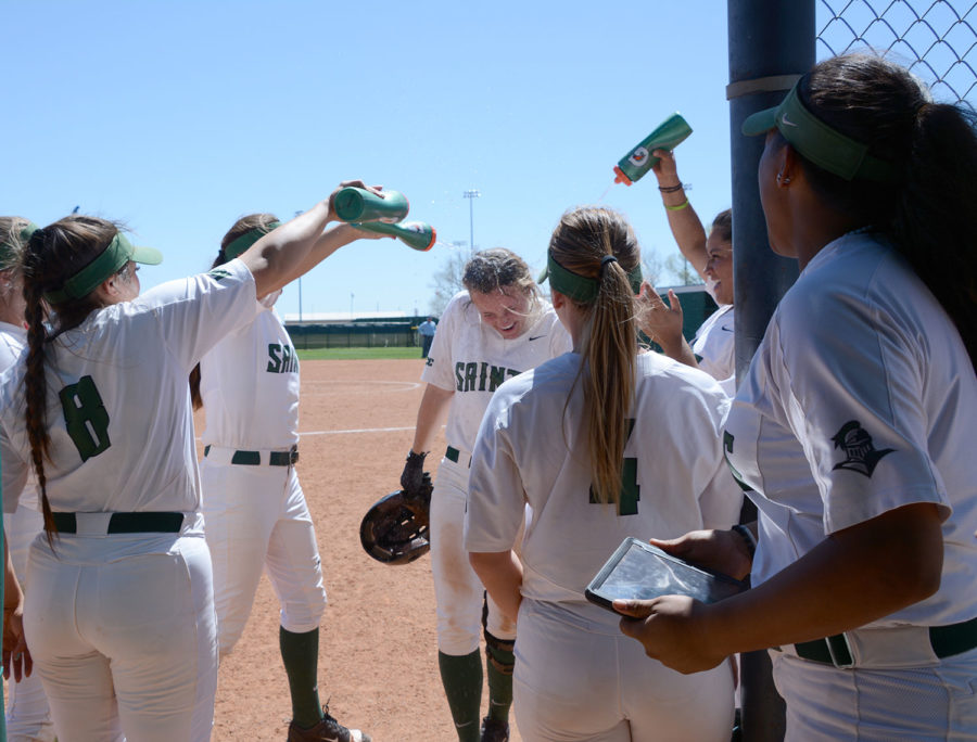 Jaci Oakley is greeted by teammates with a dousing of water after hitting a homerun against Northwest Technical College.