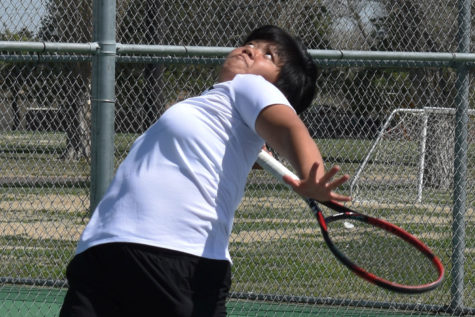 Eva Liu from Nantou County, Taiwan serves in the first game of a doubles match against Cowley College. She is ranked No. 3 for the Lady Saints.
