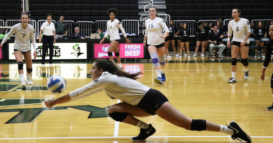 Sophomore outside hitter, Tapanga Johnson, dives for a hard spike and gets the ball up to Laura de Pra.

