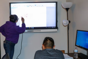 When the internet goes out, everyone has to get creative to teach and get their jobs done. Students in the TRIO office were still able to do math via a wire connection to the smart screen.