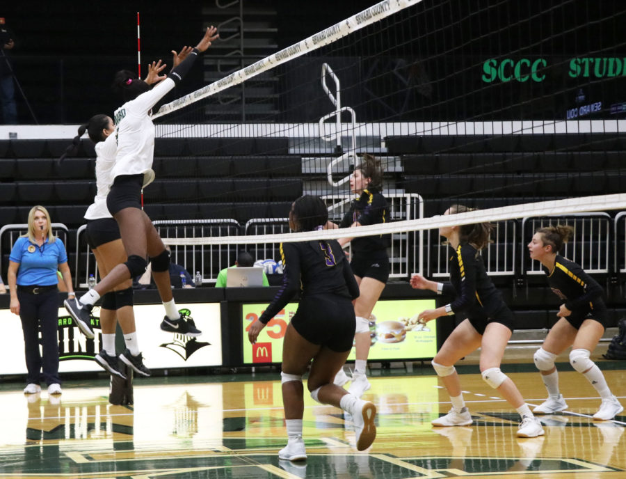 Two Lady Saints gnail a block against the Lady Conqs in Wednesdays game. Seward won in convincing fashion, 3-0.