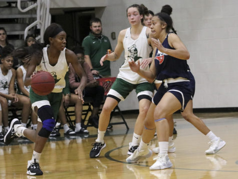 Aquila Mucubaquire swings the ball from the other side to set up the play during a recent scrimmage against Panhandle State University. She is a sophomore and plays guard for Saints. Saints basketball will take centerstage on Tuesday as part of the annual Basketball Preview Night. Doors open at 5:30 p.m. and admission is free.