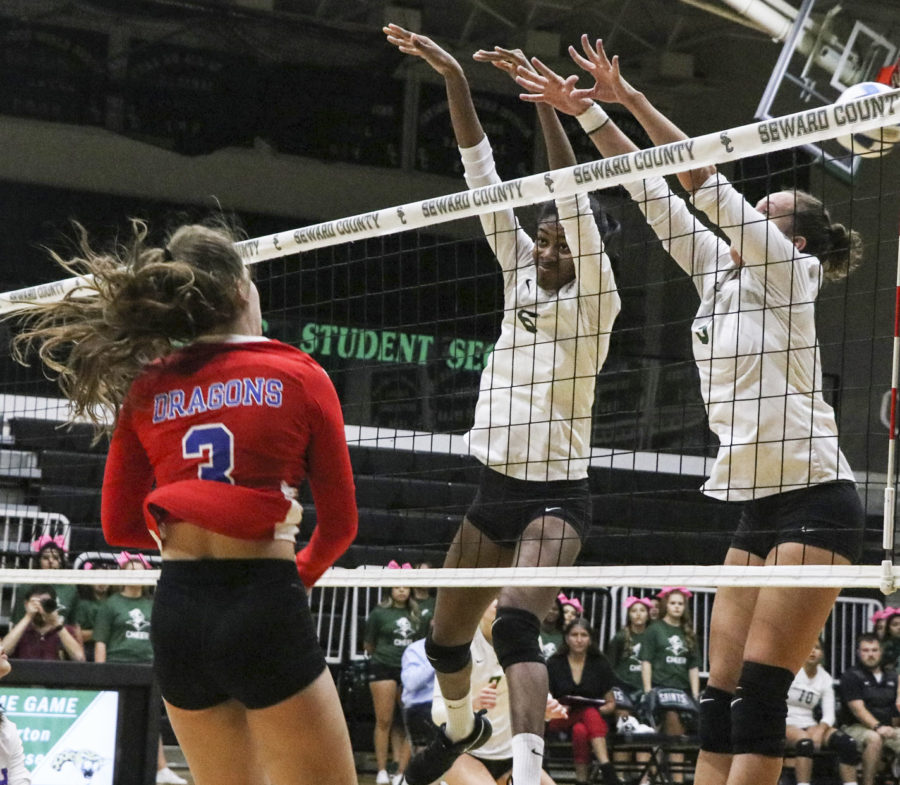 Mesalina Serverino, freshman, and Djuly Schmorantz, sophomore, get a block against the Lady Dragons and stops them from scoring. 