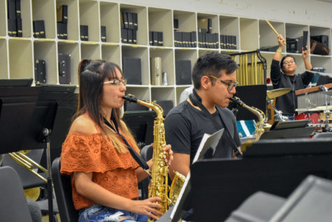 Music majors, Ruby Molina and Miguel Armendariz, play their alto saxophones, while sophomore Maggie Ibarra adds cowbell to a latin tune.